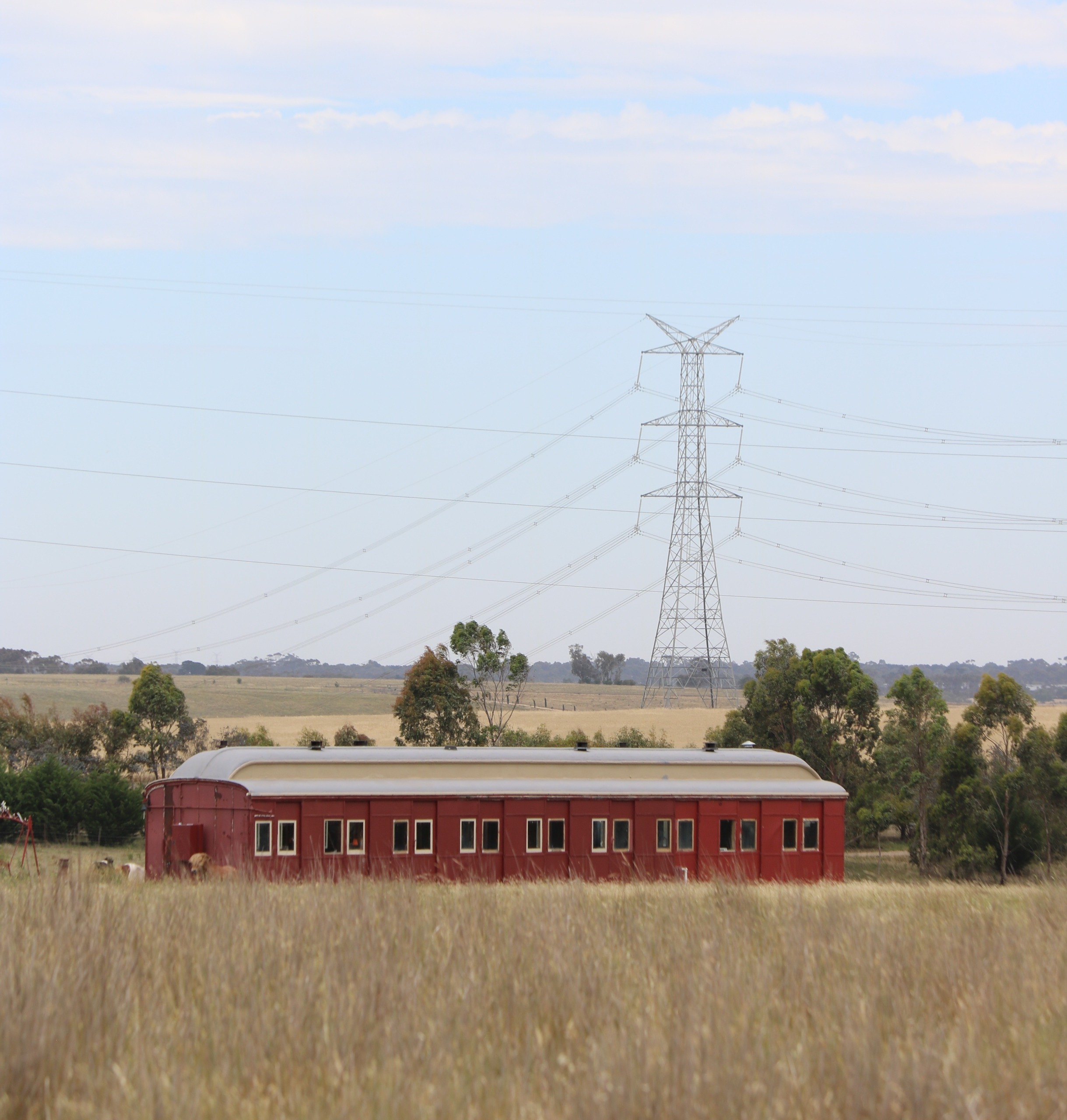 500 kV transmission infrastructure and red rattler train carriage